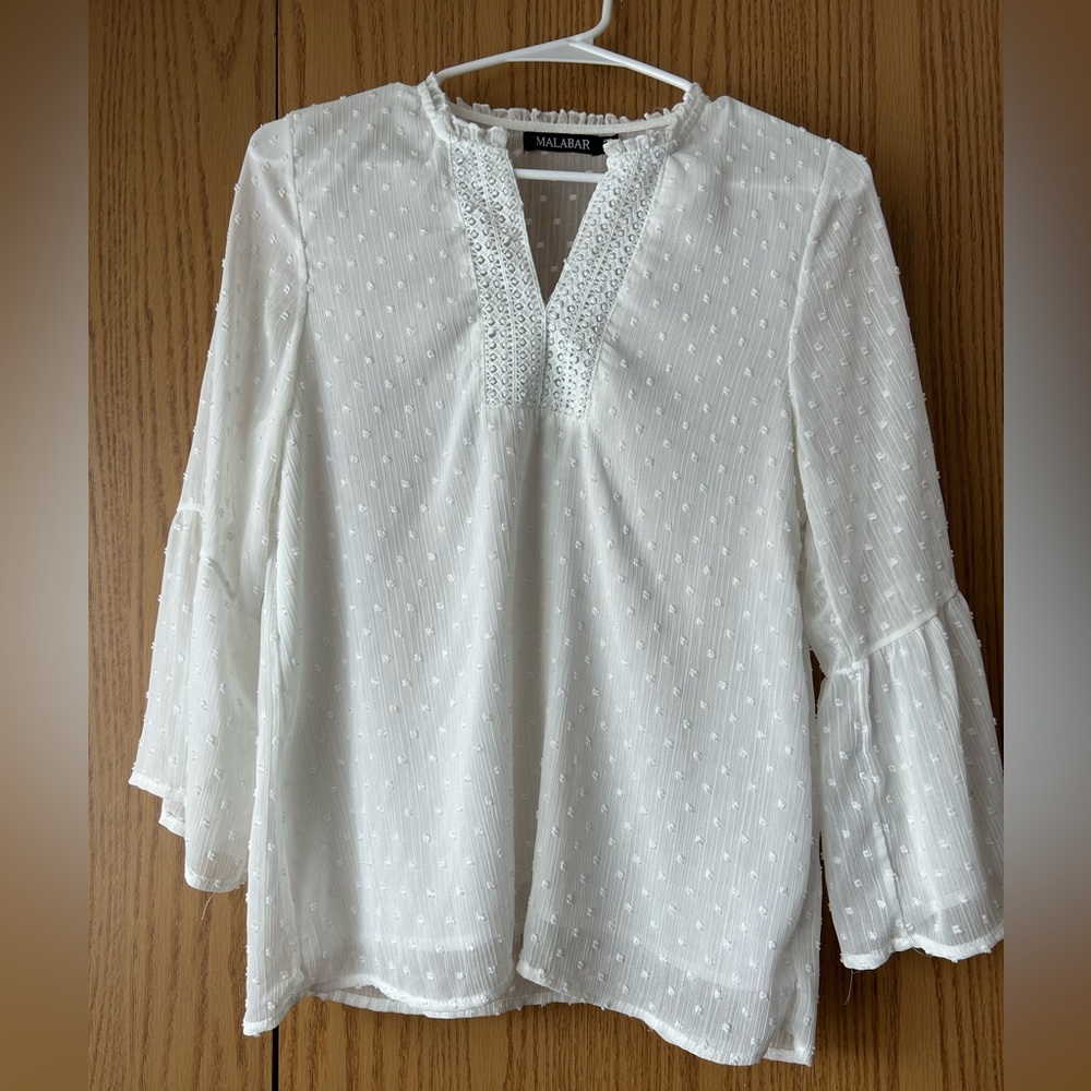 White blouse long sleeves, very fresh the back it’s a little transparent.